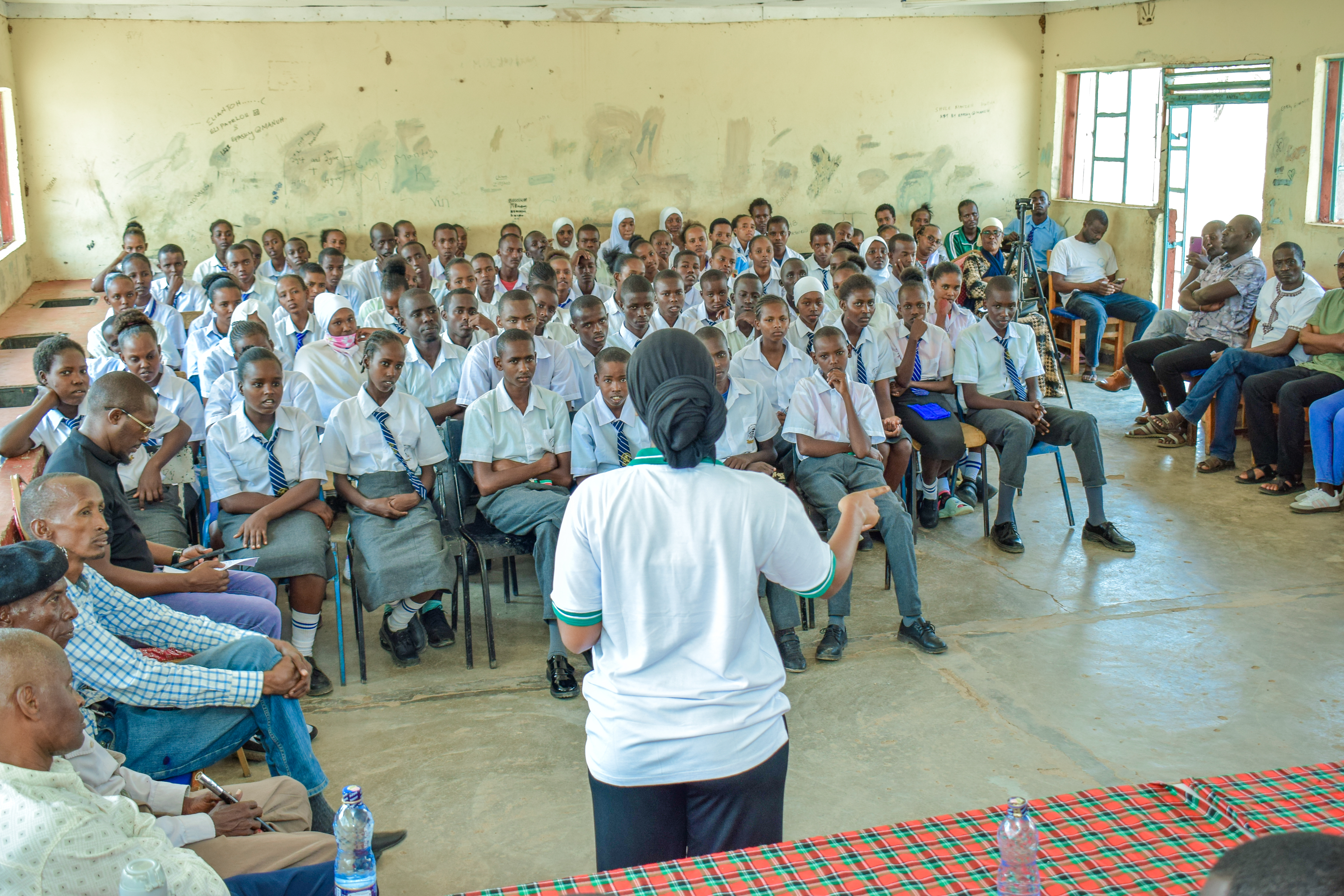 Mentor supporting girls in class